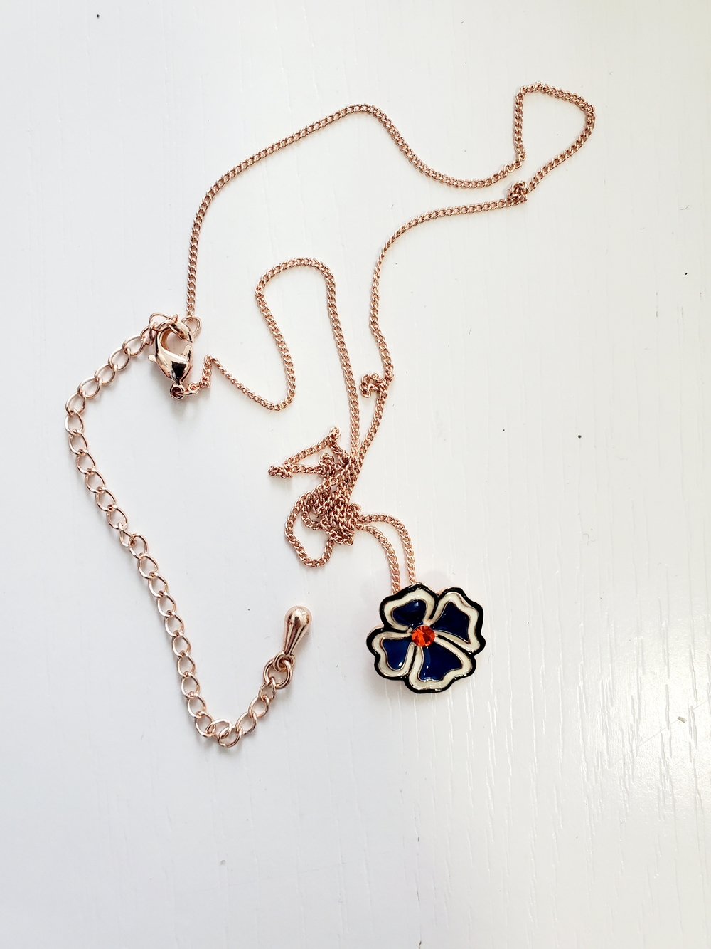 Rose Gold Flower Pendant Necklace with Black Enamel and Red Accent